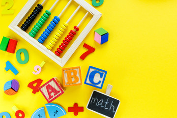 Wall Mural - Colorful math fractions on yellow background. Blocks with title School on the table. Interesting, fun math for kids. Education, back to school concept	