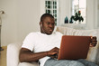 © SHOTPRIME STUDIO - A man of African appearance in front of a laptop at home