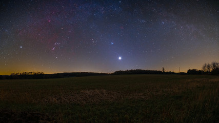 Wall Mural - Night sky including the Orion constellation, the bright planet Venus, and the Zodiacal light photographed from Bullau in the Odenwald in Germany.