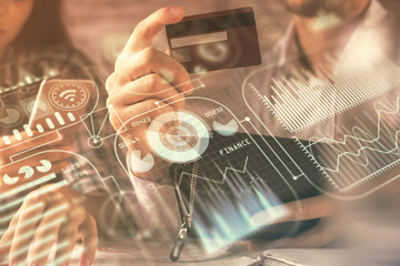 Aufkleber - Double exposure of man and woman on-line shopping holding a credit card and tech theme hologram drawing. Technology concept.