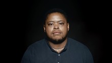 African American Man On Black Background. African Male Staring At Camera.
