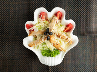 Poster - top view of caesar salad served in hand-shaped plate