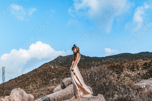 Plakat beautiful young stylish woman in elegant dress outdoors at sunset