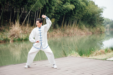 Asian aged man tai chi at the lake