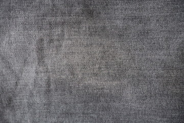 Closeup of black jeans fabric with texture and rough surface in black and white or gray vintage tone for background and decoration. Textile texture concept and cool banner on page and cover