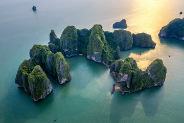 Aerial view floating fishing village and rock island, Halong Bay, Vietnam, Southeast Asia. UNESCO World Heritage Site. Junk boat cruise to Ha Long Bay. Popular landmark, famous destination of Vietnam