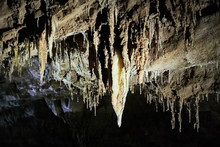 Beautiful Colorful And Illuminated Cave With Stalactites And Stalagmites