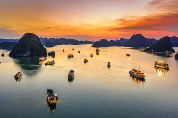 Aerial view floating fishing village and rock island, Halong Bay, Vietnam, Southeast Asia. UNESCO World Heritage Site. Junk boat cruise to Ha Long Bay. Popular landmark, famous destination of Vietnam