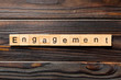 engagement word written on wood block. engagement text on table, concept