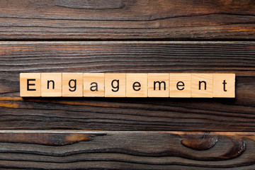 Wall Mural - engagement word written on wood block. engagement text on table, concept