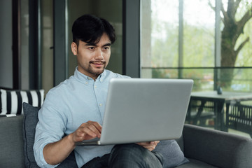 A young Asian business man is working