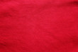 Red fabric texture background, empty cotton red cloth wallpaper. Soft textile material, close up top view of simple wavy t-shirt structure, fashion clothes plain unprinted design