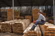 © Med Photo Studio - Portrait of young man carpenter at the wooden warehouse is resting