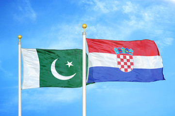 Pakistan and Croatia two flags on flagpoles and blue cloudy sky