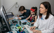 © David Pereiras - Woman teleworking with her children doing homework. Selective focus on children in background