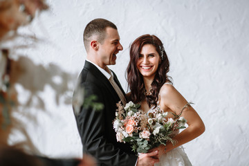 The bride and groom laugh hard. The moment of the wedding ceremony