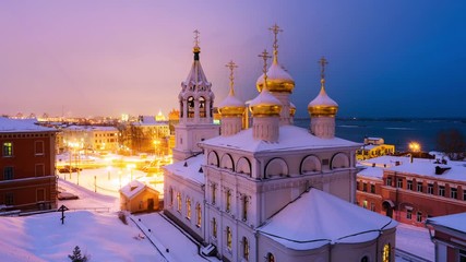 Wall Mural - Nizhny Novgorod, Russia. Aerial view of Church of the Nativity of John the Precursor in Nizhny Novgorod, Russia at night in winter. Snow and colorful sunset sky. Time-lapse