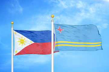 Philippines and Aruba two flags on flagpoles and blue cloudy sky