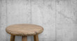 Antique wooden bar stool on background of grungy concrete wall