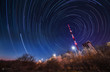 Night sky star trail over the television mobile radio tower