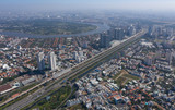 Fototapeta Miasto - Top view aerial photo from flying drone of a Ho Chi Minh City with development buildings, transportation, energy power infrastructure