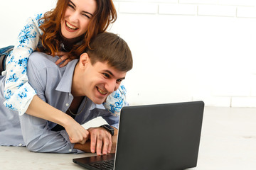 Couple buying online together with a laptop on a desktop at home