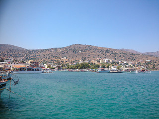 Elounda, Crete, Greece - September 2: View of the sea bay with boats. Mountains are visible in the distance.