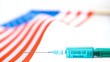 The waving flag of the USA and the coronavirus vaccine COVID-19