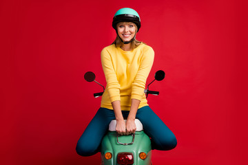 Poster - Portrait of her she nice attractive pretty lovely winsome cheerful cheery girl sitting on moped new electric transport vehicle isolated on bright vivid shine vibrant red color background