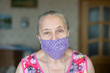 old woman in protective mask on home quarantine