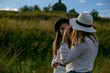 © Serafima - horizontal portrait of two beautiful girls in white clothes on a background of a countryside landscape