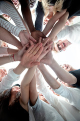 bottom view . group of young people joining their palms together