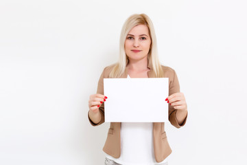 Wall Mural - Your text here. Pretty young excited woman holding empty blank board. Studio portrait on white background. Mock up for design