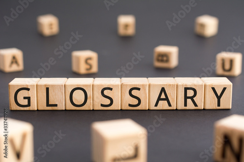 Glossary - word from wooden blocks with letters, alphabetical list of terms glos Fototapet