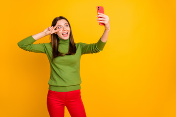 Poster - Positive cheerful funky girl have winter rest relax abroad make selfie on her smartphone show v-sign wear stylish trendy outfit isolated over yellow color backround