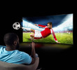 © alphaspirit - Viewer in front of a tv on the armchair at home feels inside the action