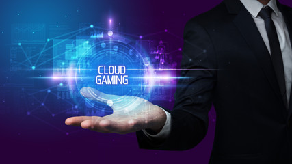 Man hand holding CLOUD GAMING inscription, technology concept