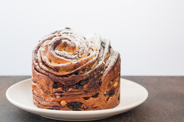 Poster - Homemade cruffin cake, made with yeast. Filled with butter, chiocolate, nuts and raisins. Minimalistic. 