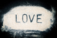 Flat Lay Of Love Word Written On Sand