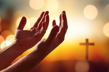 Poster - Silhouette of human hands praing with cross on the background