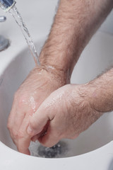 detail of man washing his hands. health and personal hygiene. virus prevention. covid-19