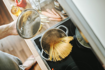 Poster - Man cooking pasta in the kitchen