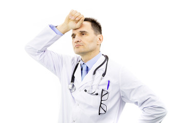 Wall Mural - Portrait of handsome physician man with glasses in chest pocket wearing medical gown and stethoscope over isolated white background tired hold hands on head feeling fatigue. Headache concept.