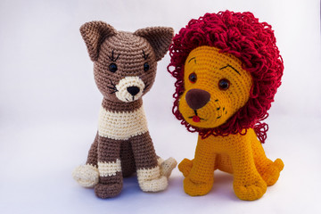 Wall Mural - Handmade dolls cat and lion amigurumi together on a white background.