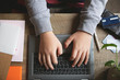 © Natalie Jeffcott - Close up of teenager hands using a laptop keyboard
