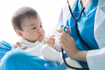 female doctor examining a baby
