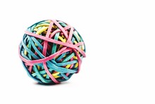 Close-up Of Ball Made With Colorful Rubber Bands Against White Background