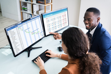 Businesspeople Analyzing Gantt Chart