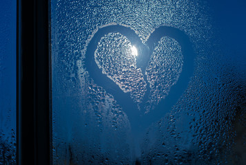 Wall Mural - Moonlight through the window. Sweaty glass and heart