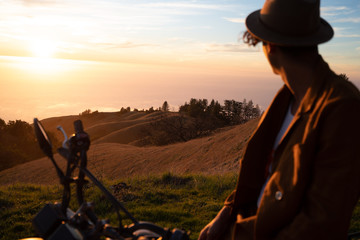 Wall Mural - biker looking at view while sitting on motorbike